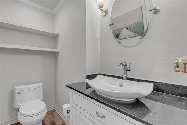 bathroom with vanity, ornamental molding, and toilet