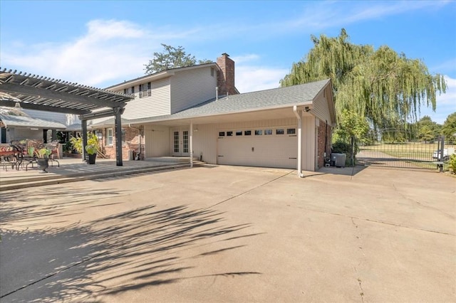 view of property exterior with a garage, a pergola, and french doors