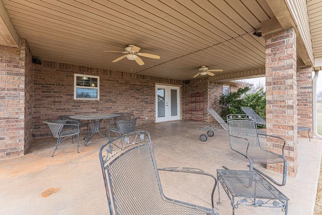 view of patio / terrace featuring french doors, outdoor dining area, and a ceiling fan