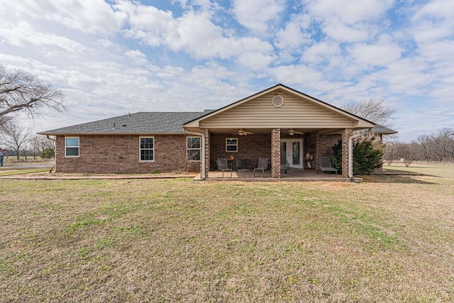 ranch-style house with ceiling fan, a patio, a front lawn, and brick siding