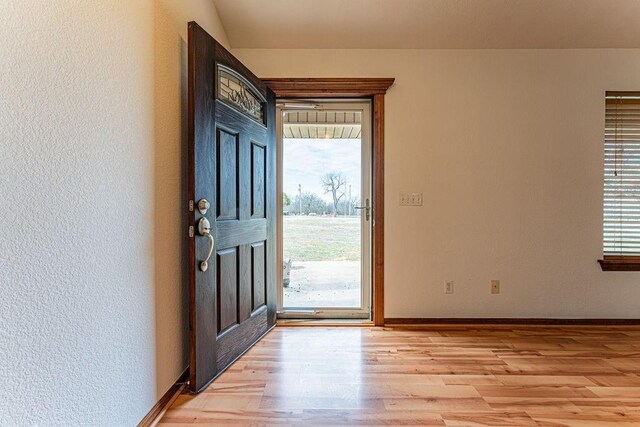 entrance foyer with light wood-type flooring and baseboards