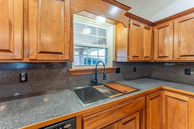 kitchen with brown cabinetry, a sink, backsplash, and dishwasher