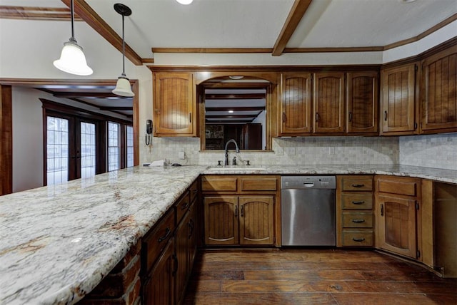 kitchen featuring dishwasher, sink, pendant lighting, and dark hardwood / wood-style floors