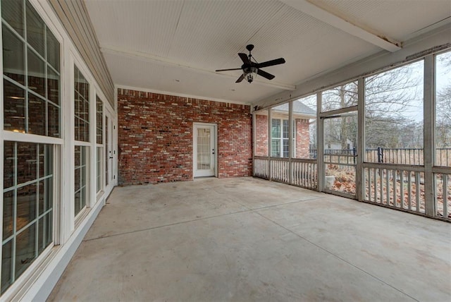 unfurnished sunroom featuring ceiling fan