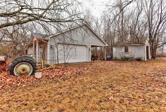 view of home's exterior featuring a garage and an outbuilding