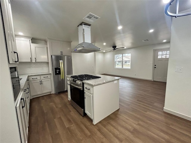 kitchen featuring white cabinetry, island range hood, a center island, appliances with stainless steel finishes, and dark hardwood / wood-style floors