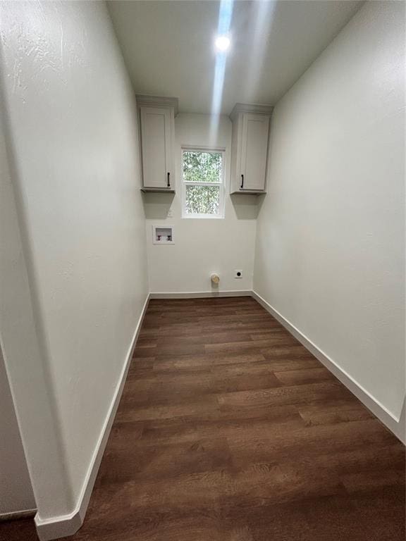 laundry area with electric dryer hookup, hookup for a washing machine, dark wood-type flooring, and cabinets