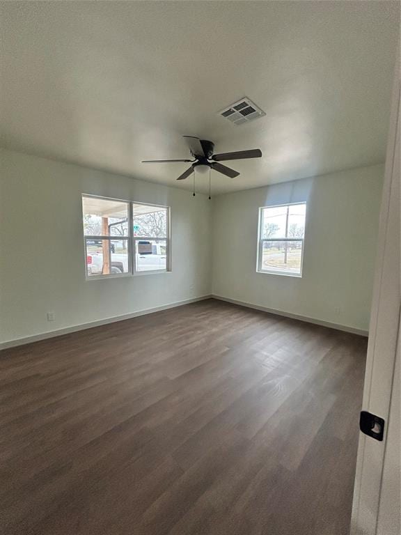 spare room featuring ceiling fan and dark hardwood / wood-style flooring