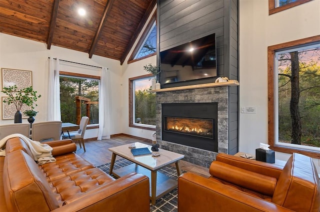 living room featuring beam ceiling, high vaulted ceiling, wooden ceiling, a fireplace, and hardwood / wood-style floors