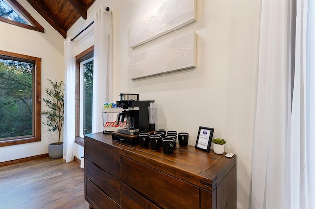 office area with wood-type flooring, lofted ceiling with beams, and wooden ceiling