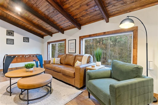 living room with vaulted ceiling with beams, wood ceiling, and light wood-type flooring