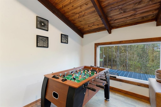 game room featuring a healthy amount of sunlight, vaulted ceiling with beams, wood ceiling, and light hardwood / wood-style floors