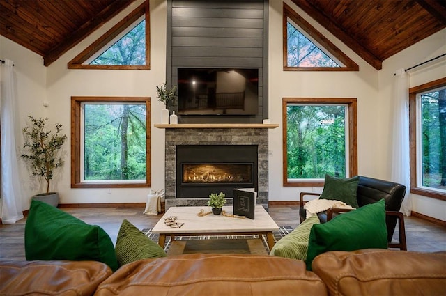 1194 Camp Ranch Rd, Broken Bow, OK 74728 - living area with wood ceiling, high vaulted ceiling, baseboards, a fireplace, and beamed ceiling