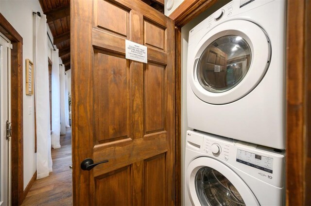 1194 Camp Ranch Rd, Broken Bow, OK 74728 - clothes washing area with stacked washing machine and dryer and wood finished floors