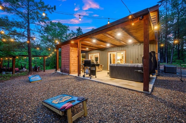 1194 Camp Ranch Rd, Broken Bow, OK 74728 - view of patio with a hot tub and central air condition unit