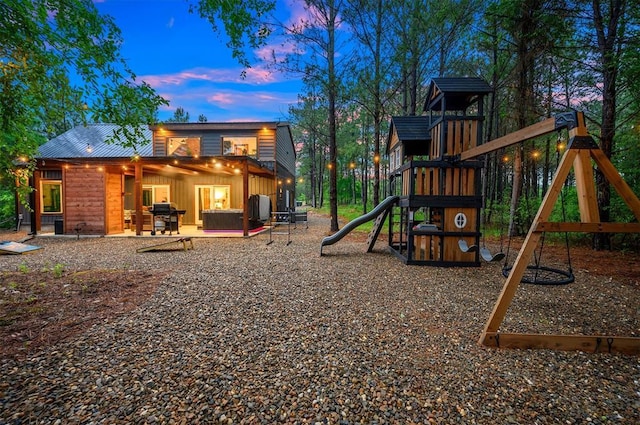 1194 Camp Ranch Rd, Broken Bow, OK 74728 - playground at dusk featuring a playground