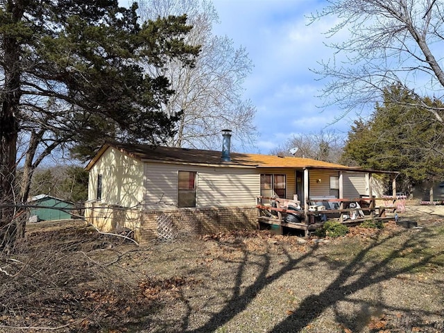 back of property featuring a deck