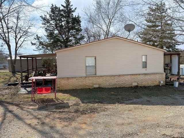 view of side of home with a carport