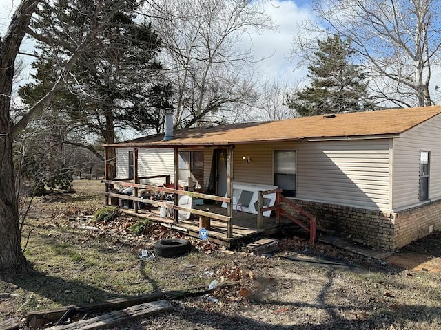 back of property featuring a deck