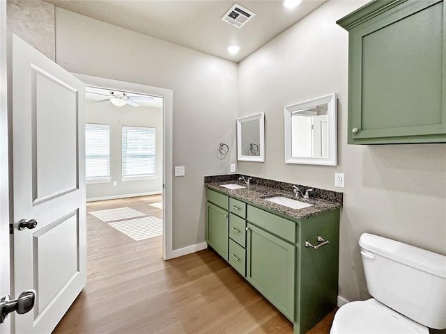 bathroom with vanity, hardwood / wood-style floors, ceiling fan, and toilet