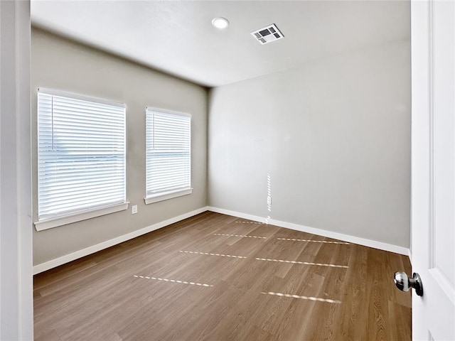 unfurnished room with hardwood / wood-style floors