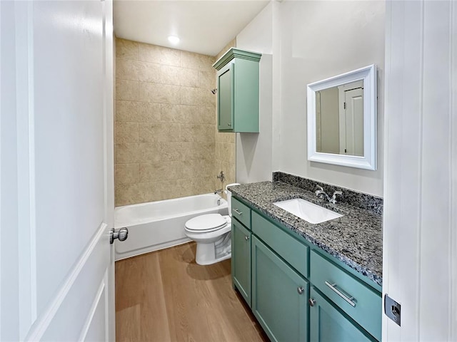 full bathroom with vanity, toilet, tiled shower / bath combo, and hardwood / wood-style floors