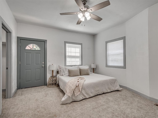 bedroom featuring light colored carpet and ceiling fan