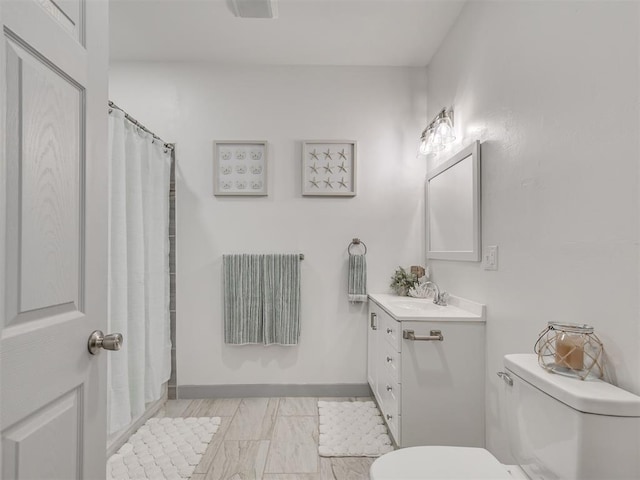 bathroom featuring a shower with curtain, vanity, and toilet