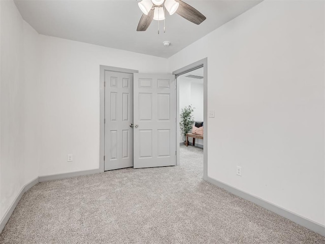 unfurnished bedroom with carpet floors, a closet, and ceiling fan