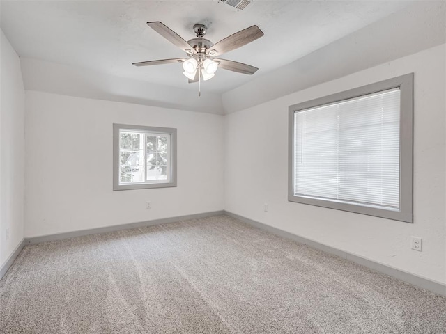 carpeted spare room with ceiling fan