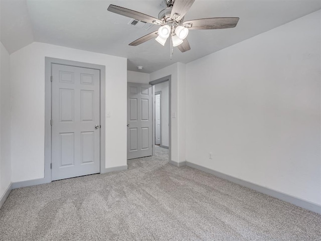 unfurnished bedroom with light carpet, vaulted ceiling, and ceiling fan