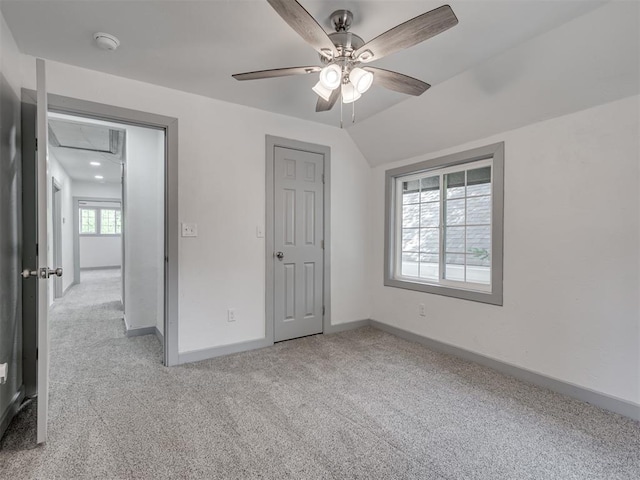 unfurnished bedroom featuring lofted ceiling, light colored carpet, and ceiling fan