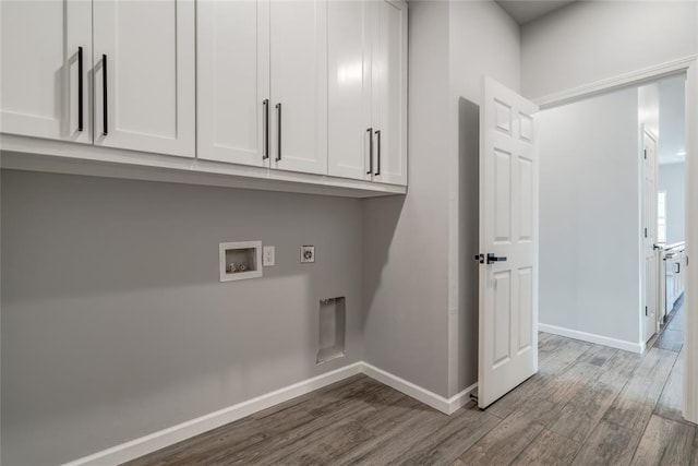 laundry room with cabinets, washer hookup, hardwood / wood-style floors, and electric dryer hookup