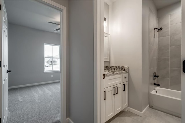 bathroom with vanity, tiled shower / bath combo, and tile patterned flooring