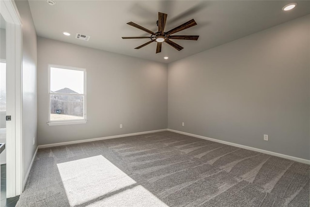 carpeted spare room with ceiling fan