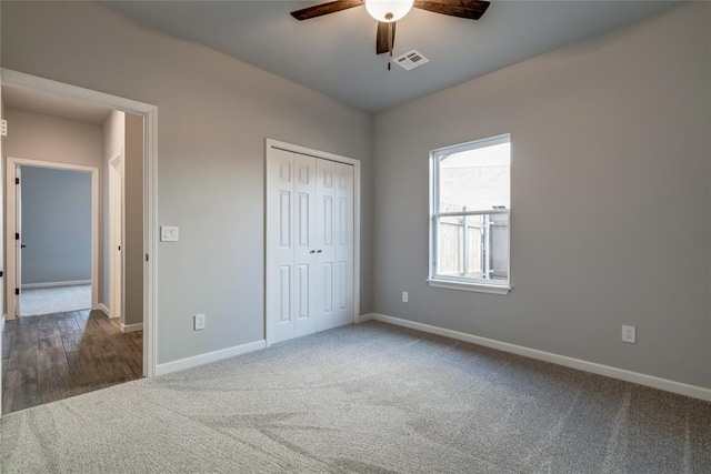 unfurnished bedroom featuring a closet, ceiling fan, and carpet