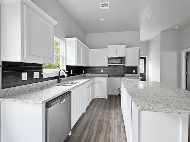 kitchen featuring sink, white cabinetry, stainless steel appliances, dark hardwood / wood-style floors, and a center island