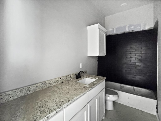 bathroom with vanity, toilet, and a bathtub