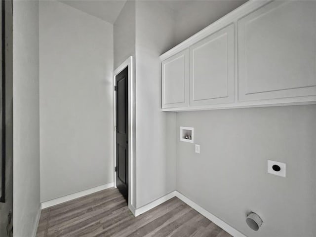 washroom with washer hookup, cabinets, wood-type flooring, and hookup for an electric dryer