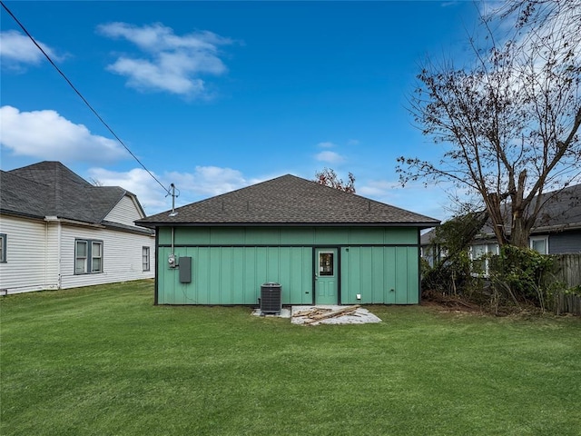 back of property featuring cooling unit and a lawn