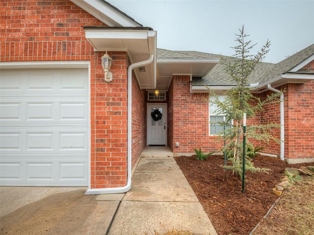 doorway to property with a garage