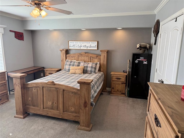 bedroom with ceiling fan, light colored carpet, and crown molding