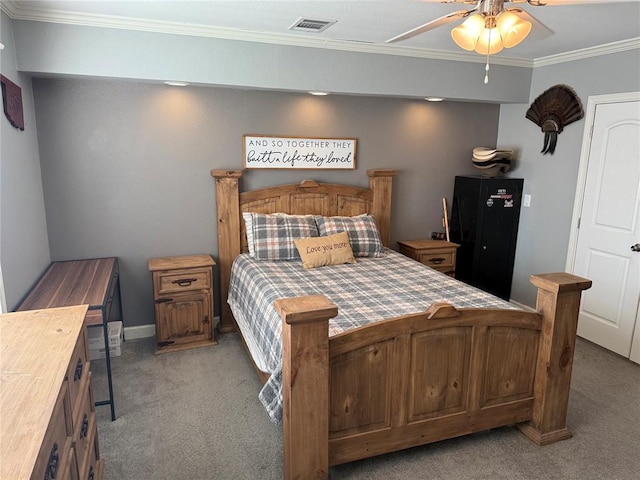 bedroom with visible vents, light carpet, crown molding, baseboards, and ceiling fan