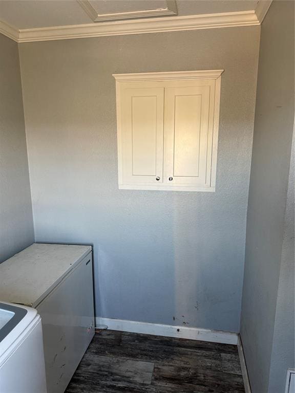 washroom featuring baseboards, cabinet space, ornamental molding, and dark wood-style flooring