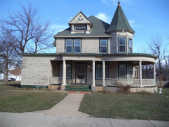 victorian home with a front yard and covered porch