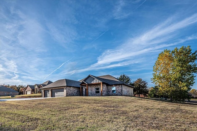 ranch-style house featuring a garage and a front lawn