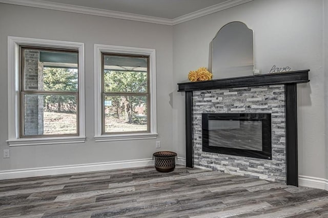 unfurnished living room featuring hardwood / wood-style floors, crown molding, and a fireplace