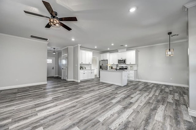 unfurnished living room featuring ornamental molding, ceiling fan, and light wood-type flooring