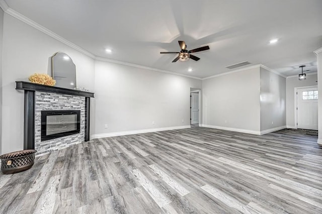 unfurnished living room featuring crown molding, ceiling fan, a fireplace, and light hardwood / wood-style flooring