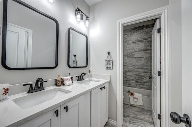 full bathroom with vanity, tiled shower / bath combo, and toilet